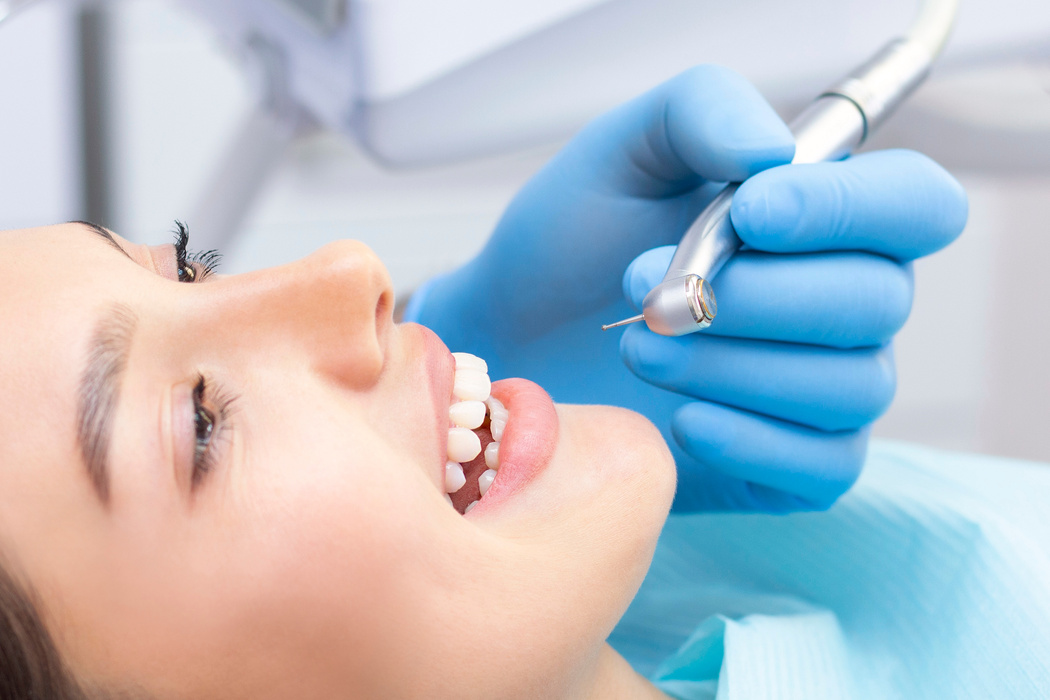 Dentist and patient in the dental office. Woman having teeth examined by dentists